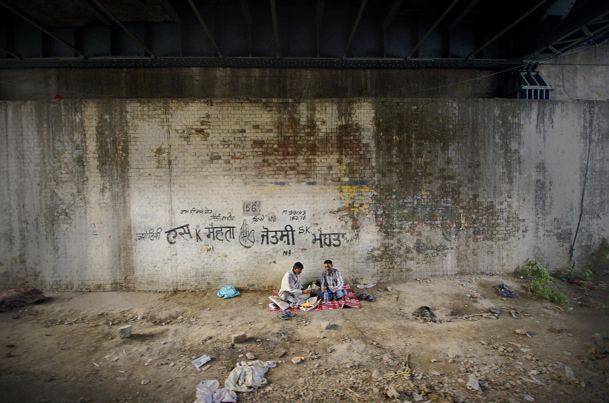 My bright and finished piece of Digital Photographic Art - a picnic under a bridge and next to the train tracks in Amritsar