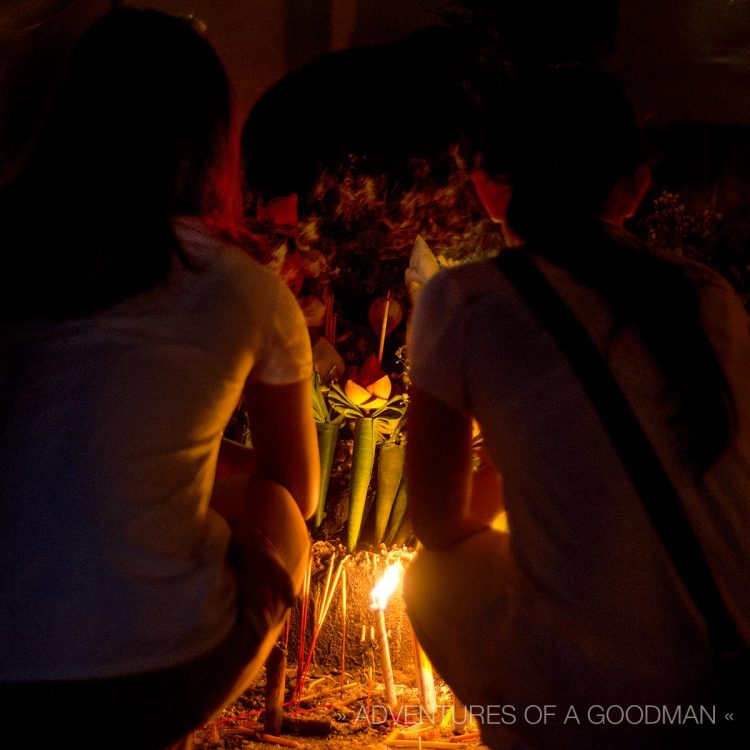 Devotees in prayer at Wat Chedi Luang in Chiang Mai, Thailand