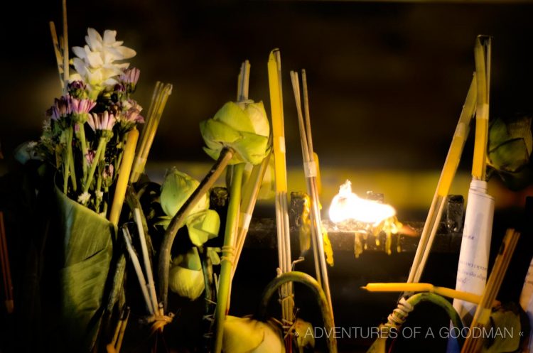 Prayer candles, incense, messages and lotus flowers at Wat Phra Singh in Chiang Mai, Thailand, on Asalaha Bucha Day