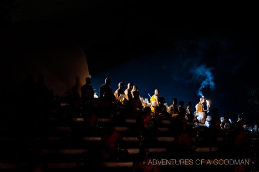 The first flame is brought down by a monk to begin lighting the fires for the Yi Peng Lantern Festival in Chiang Mai, Thailand