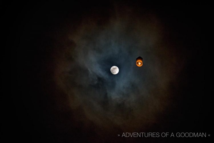 The moon's magic is enhanced by a sea of lanterns floating around it