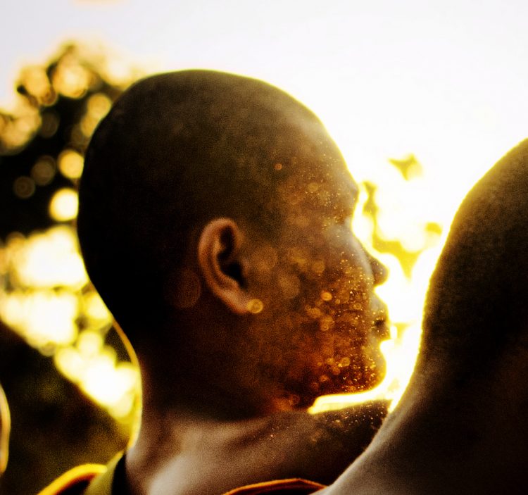 A closeup of the monk's face, surrounded by an energy field emanating from him and the digital camera