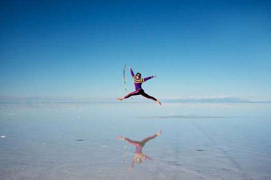 Carrie leaping in the Salar de Uyuni salt flats in Bolivia