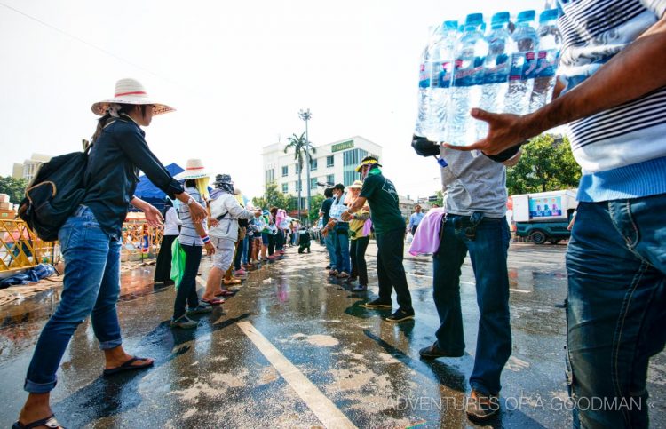 Protesters lined up to move bottled water from trucks to the front of the Democracy Monument.