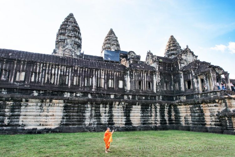 A lone monk photographing the back entrance to Angkor Wat.