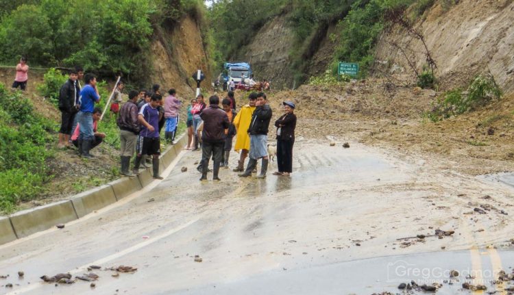 Locals used the landslide as an invitation to stand around, chat and hang out.