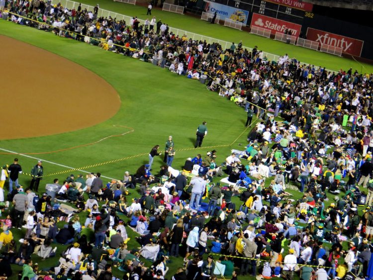 Fans storm the field after the baseball game.