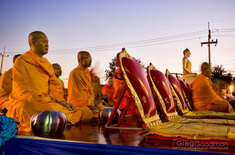 Distinguished monks assembled on stage before dawn