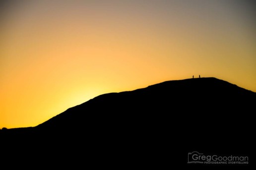 A couple watches the sunset from Goat Rock along the Sonoma Coast