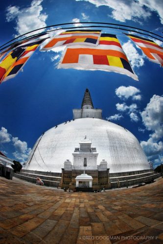 Prayer flags cover the sun at the Ruvanvelisaya Dagoba in Sri Lanka