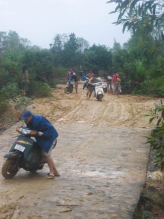 Pushing our bikes through the mud