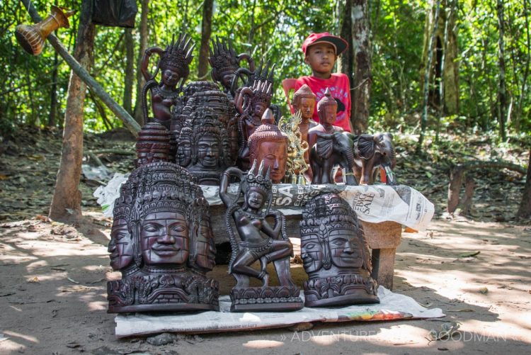 A little boy sells souvenirs at Ta Phrom, Angkor, Cambodia