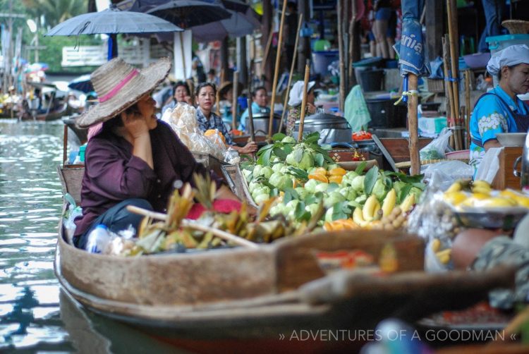A fruits and veggies vendor takes a break to chat at the Damnoen Saduak Floating Market
