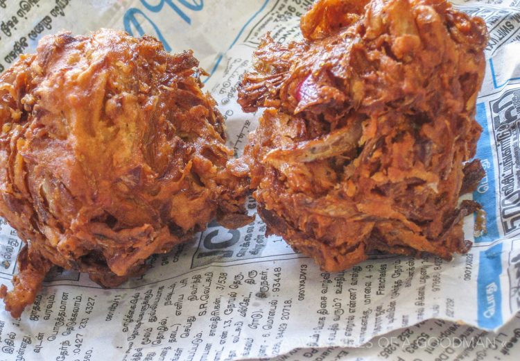 A fried vegetable pakora, filled with onions