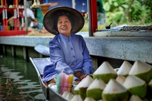 A coconut vendor at the Damnoen Saduak Floating Market