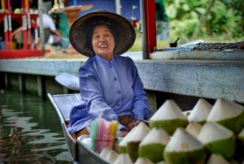 A coconut vendor at the Damnoen Saduak Floating Market