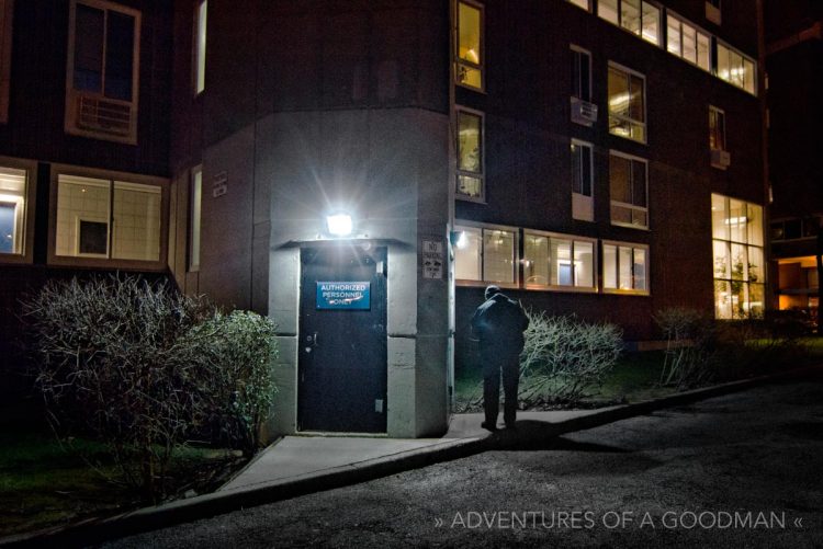 A man smoking a cigarette outside of the Eastwood apartment complex on Roosevelt Island