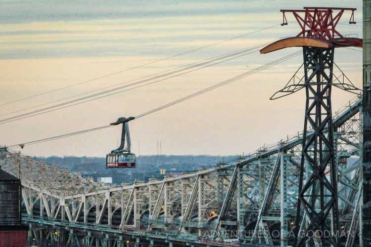 A shot of the Roosevelt Island Tram next to the Queensboro Bridge, shot from a rooftop in uptown Manhattan