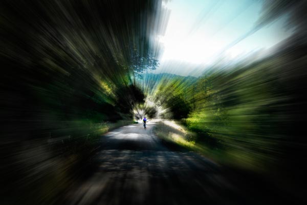 A biker zooms his way down Old La Honda Road in the Santa Cruz Mountains in Northern California