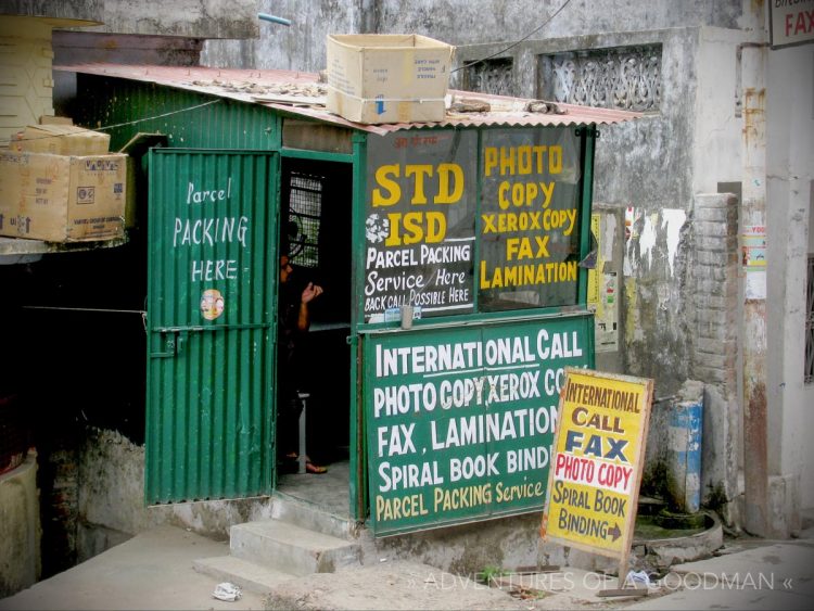 A hardwired phone line and antique photocopier sit inside this metal shack, which serves as a phone booth and copy center