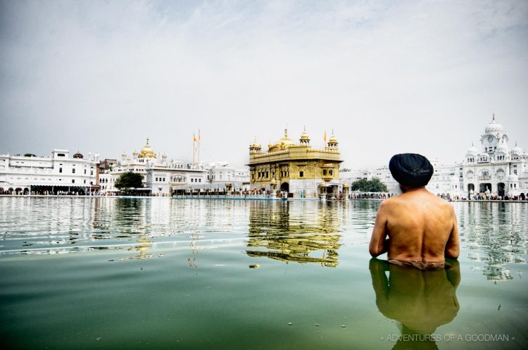 A Sikh man takes a bath in the holy pool (Sri Harmandir Sahib) at the Golden Temple in Amritsar, India