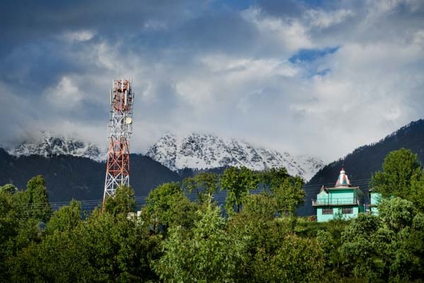 The Himalayas tower high above Naddi, in McLeod Ganj, Dharamasala