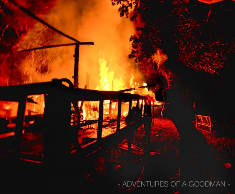 A member of the bucket brigade hard at work dousing a bungalow with water to stop the spread of the blaze