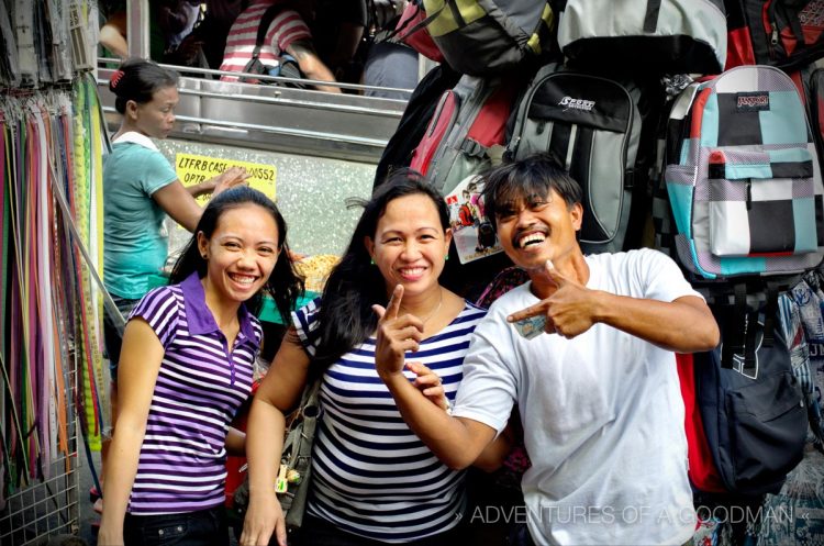 A backpack vendor and his friends at the Baclaran Market - Manila, Philippines