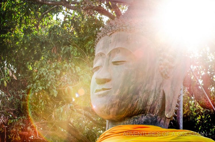 Auras surround a Buddha statue at Wat That Khao just before sunset