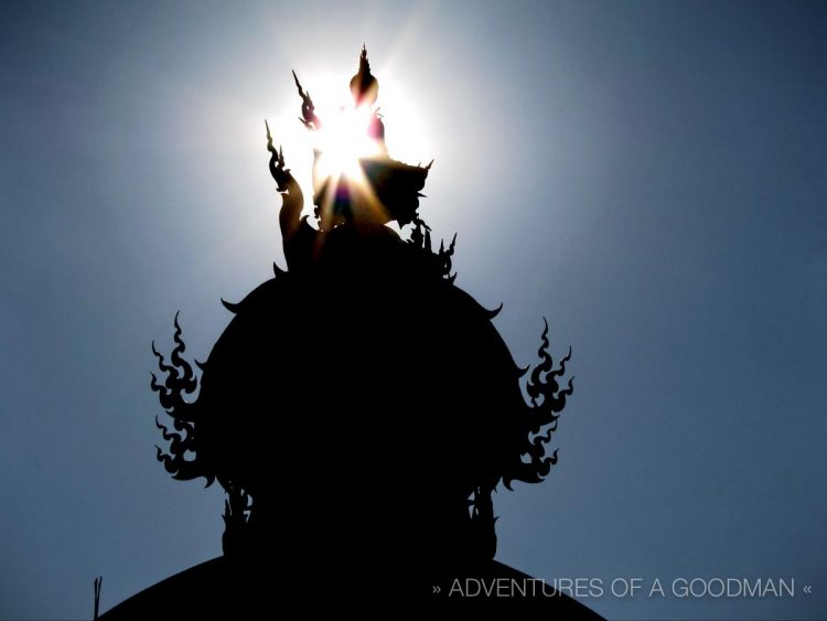 The sun shines through a Buddha statue at the White Temple in Chiang Rai, Thailand