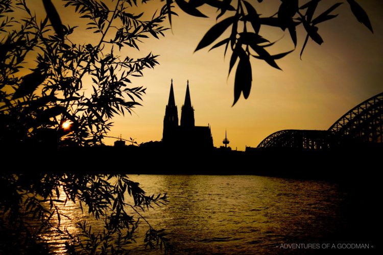 Sunset over the Rein River in Cologne, Germany, with the Kolner Dam and Hohenzollern Bridge