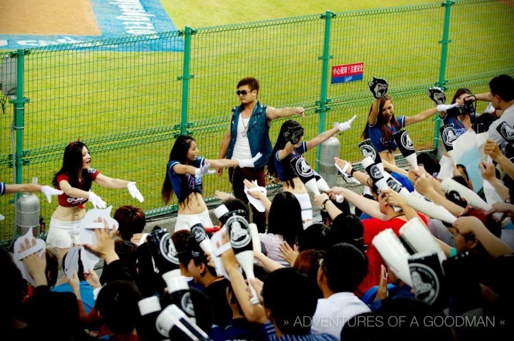 Fans of the Lamigo Monkeys celebrate after their team scores a run