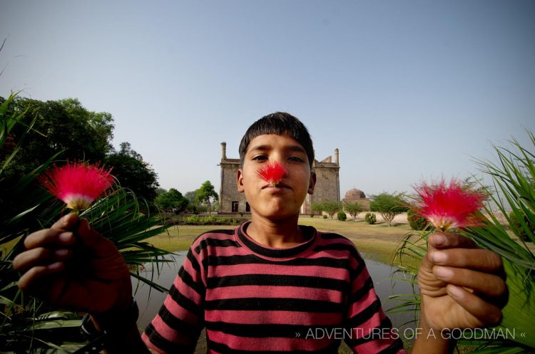 An Indian boy showing off the local flowers at Chini-Ka-Rauzah Tomb