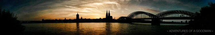 A panorama of the Rein River in Cologne, Germany, with the Kolner Dam and Hohenzollern Bridge