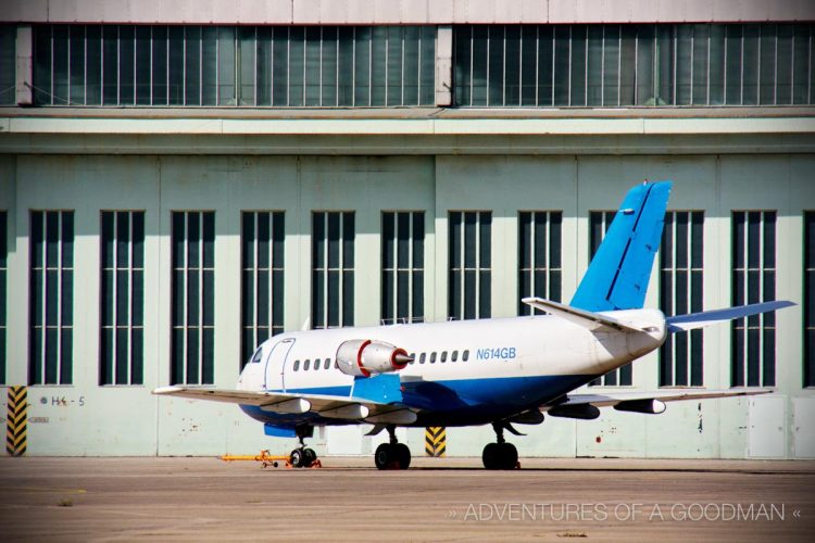 A small jet parked outside the main terminal of Berlin's Tempelhofer Airport