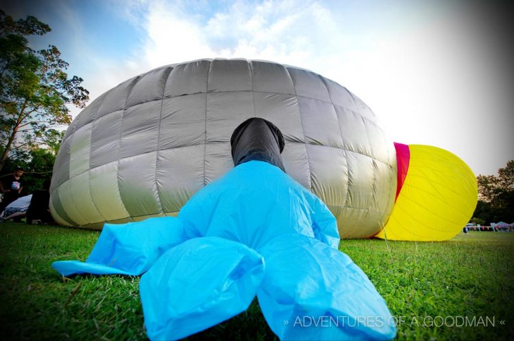 A face down clock in the process of being inflated in the late afternoon at the Thailand International Balloon Festival at Chiang Mai Gymkhana Golf Club