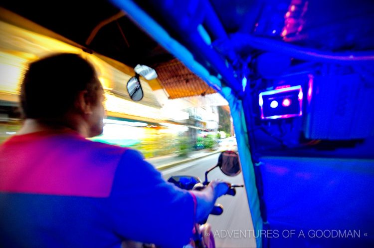 Tricycle Motor driver at night with a motion blur in Manila, Philippines