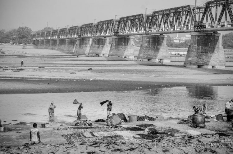 Women beating saris near the Yamuna River in Agra, India