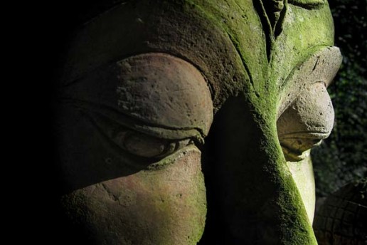 A mossy Buddha face at the Baan Phor Liang Meun's Terra-Cotta Arts garden in Chiang Mai, Thailand