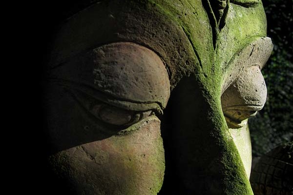 A mossy Buddha face at the Baan Phor Liang Meun's Terra-Cotta Arts garden in Chiang Mai, Thailand