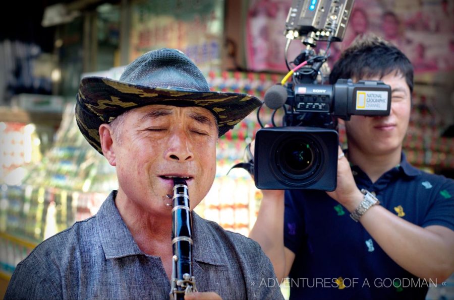 This man sells fried seafood on a stick and plays the clarinet to attract customers and stave-off boredom. He’s been doing it for nearly 20 years. Behind him is our National Geographic Channel cameraman filming a scene for the show.