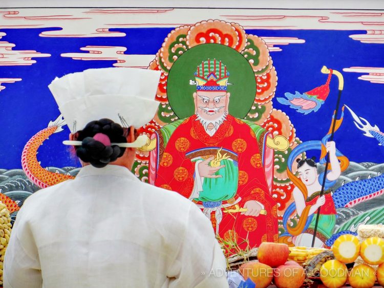 A Mudang prays to the Dragon King during a gut