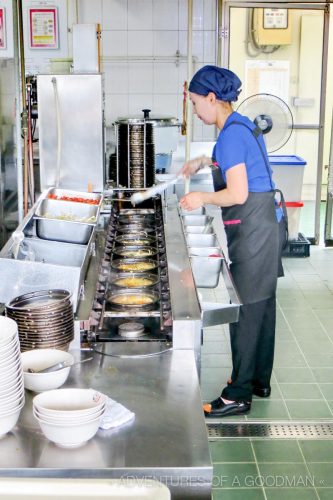 A woman works on the raymun noodle assembly line