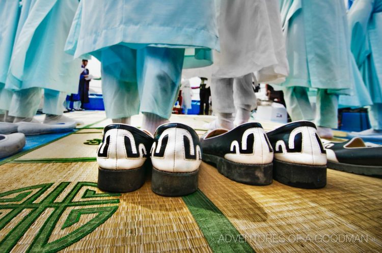 Shaman holy men take off their shoes before standing in front of the alter to the Sea God