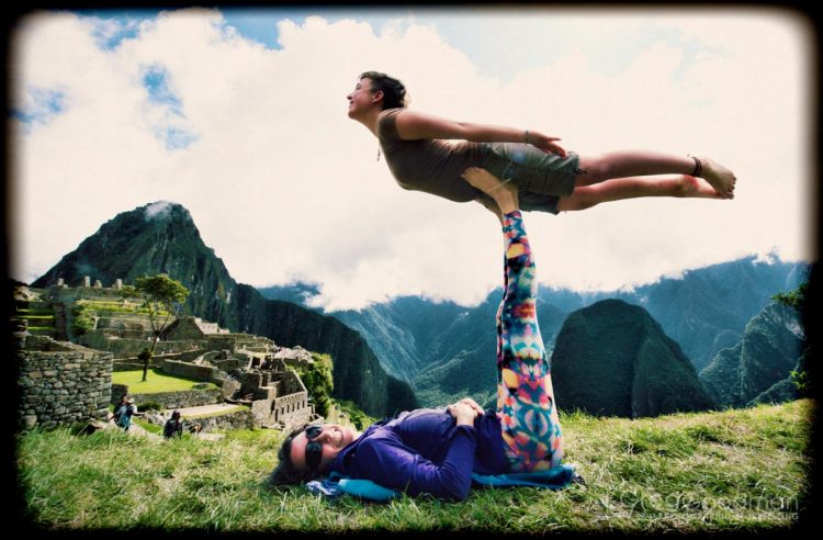 Carrie lifts Jessica up into the Acro Yoga pose known as "Bird."