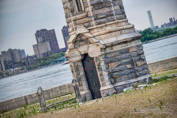 The Roosevelt Island Lighthouse is currently surrounded by tall weeds.