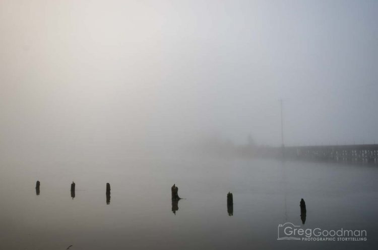 A foggy train bridge over the Smith River in Oregon