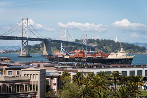 A giant cargo ship is docked alongside the Bay Bridge and the Embarcadero - as seen from the upper deck