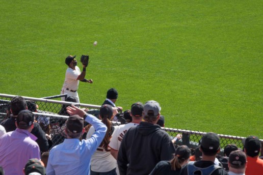 Jarrod Parker tracks down a fly ball on the left field warning track