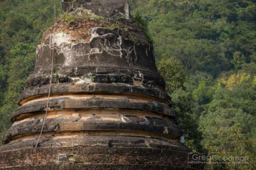 Moss, vines, and old brick adorn this ancient stupa at Wat Chedi Ngam